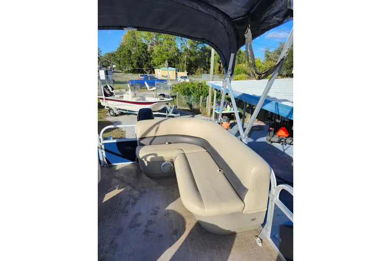 Slide: The Image of 2022 Sun Tracker Bass Buggy 16 XL Select pontoon boat with beige seating and canopy. - 19