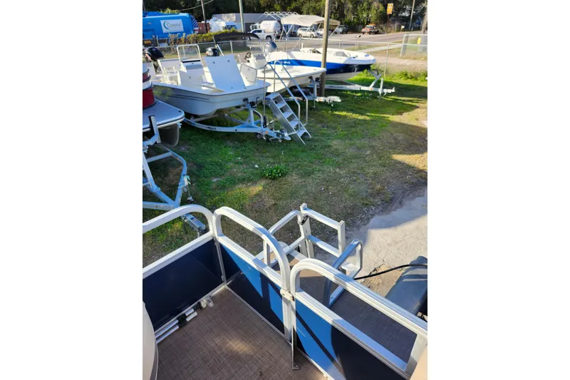 Slide: The Image of 2022 Sun Tracker Bass Buggy 16 XL Select pontoon boat in a boatyard. - 23