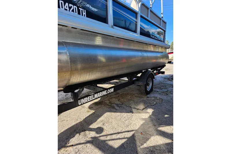 Slide: The Image of 2022 Sun Tracker Bass Buggy 16 XL Select pontoon boat on trailer. - 25