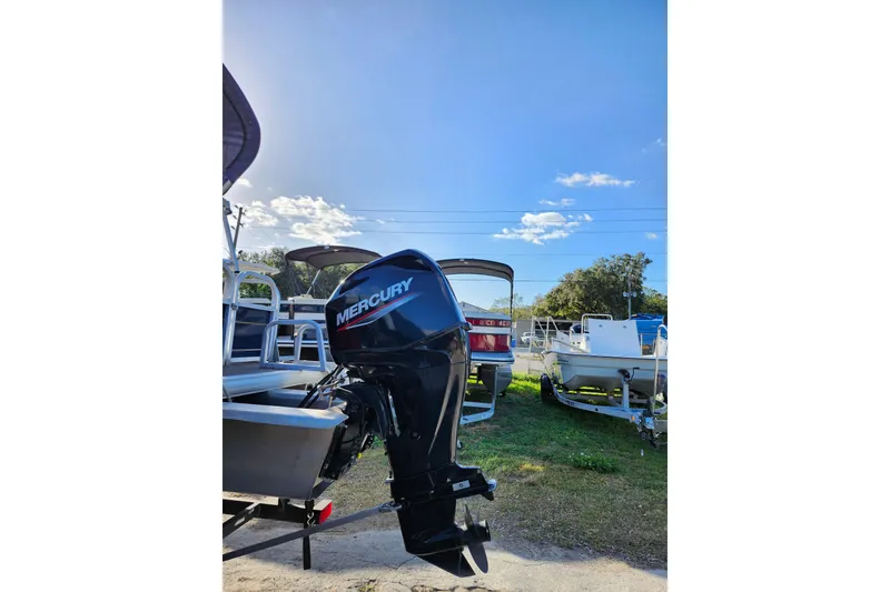 Slide: The Image of 2022 Sun Tracker Bass Buggy 16 XL Select with Mercury outboard motor in a sunny outdoor setting. - 8