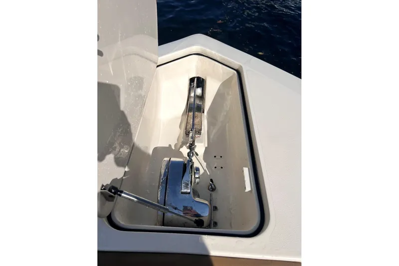 Slide: The Image of Anchor compartment of 2013 Scout 275 LXF boat, open with visible chain and mechanism. - 17