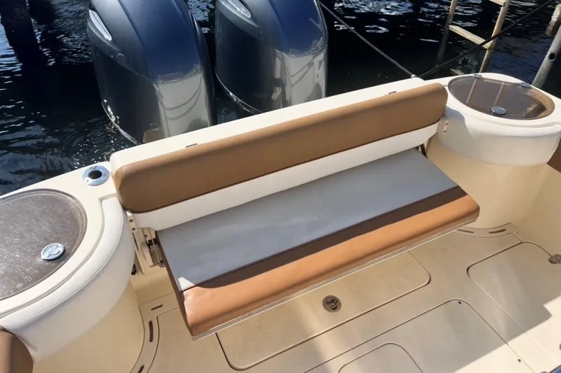 Slide: The Image of 2013 Scout 275 LXF boat with cushioned seating and dual outboard motors. - 2