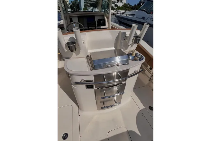Slide: The Image of 2013 Scout 275 LXF boat interior with fishing rod holders and storage drawers. - 4