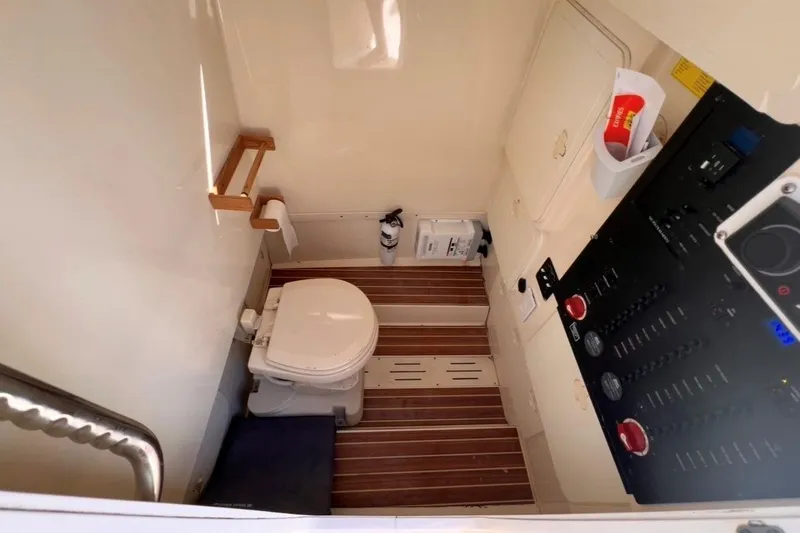 Slide: The Image of 2013 Scout 275 LXF boat interior with toilet and control panel. - 6