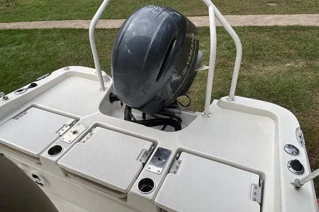 Slide: The Image of 2021 NauticStar 211 Hybrid boat with Yamaha outboard motor, featuring storage compartments. - 10