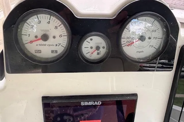 Slide: The Image of 2021 NauticStar 211 Hybrid dashboard with Yamaha gauges and Simrad display. - 12