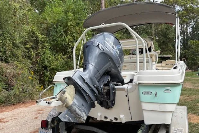 Slide: The Image of 2021 NauticStar 211 Hybrid boat with Yamaha outboard motor, parked on a trailer. - 3