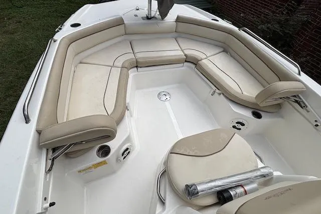 Slide: The Image of 2021 NauticStar 211 Hybrid boat interior with beige seating and white deck. - 4