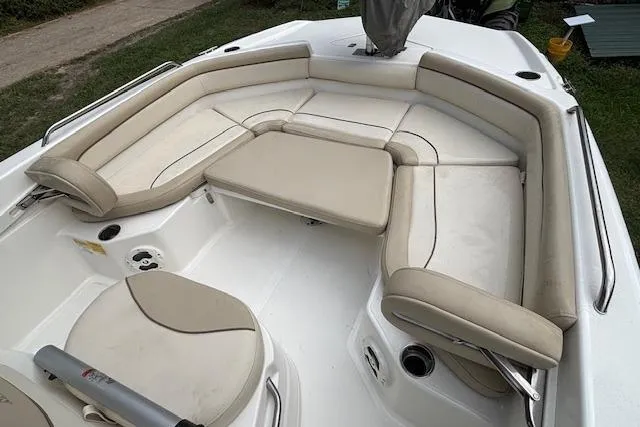 Slide: The Image of 2021 NauticStar 211 Hybrid boat with beige seating and spacious deck layout. - 7