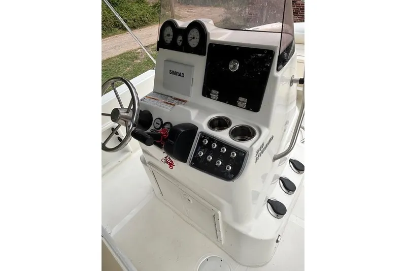 Slide: The Image of 2021 NauticStar 211 Hybrid boat console with steering wheel and controls. - 8