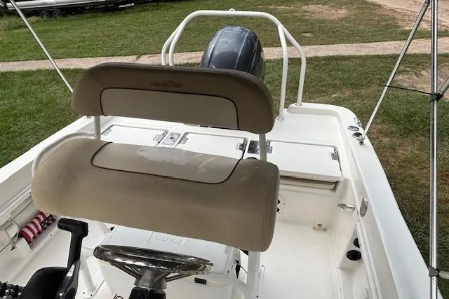 Slide: The Image of 2021 NauticStar 211 Hybrid boat interior with seating and steering wheel. - 9