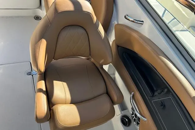Slide: The Image of 2023 Crownline Eclipse E235 XS boat interior with tan leather seating. - 2