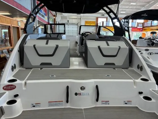 Slide: The Image of Yamaha Boats AR220 2026 in showroom, featuring modern design and seating arrangement. - 4