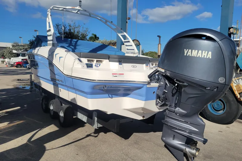 Slide: The Image of 2025 Chaparral 21 SSi OB boat with Yamaha outboard motor, parked on a trailer. - 10
