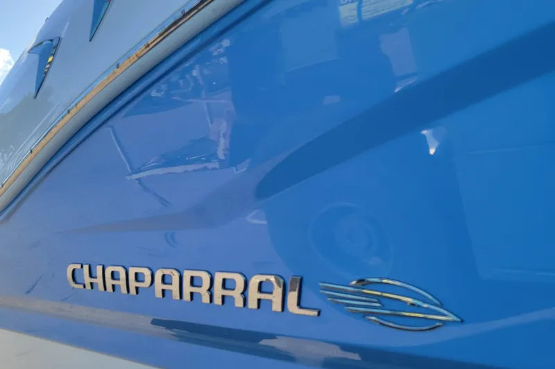 Slide: The Image of 2025 Chaparral 21 SSi OB boat logo on blue hull. - 7