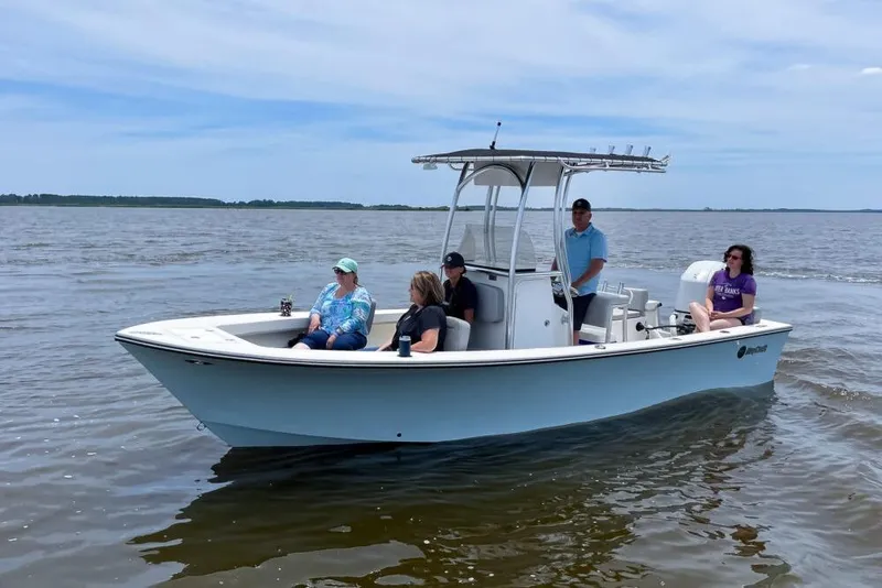 The Image of 2023 Maycraft 208 boat cruising with passengers on a calm, sunny day. - 0