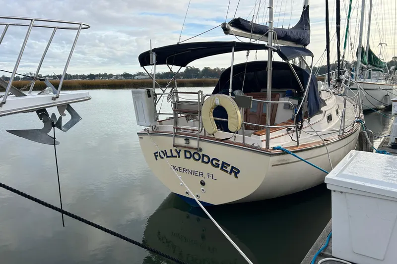 Slide: The Image of 1997 Island Packet 29 sailboat docked, named "Folly Dodger," in Tavernier, Florida marina. - 1