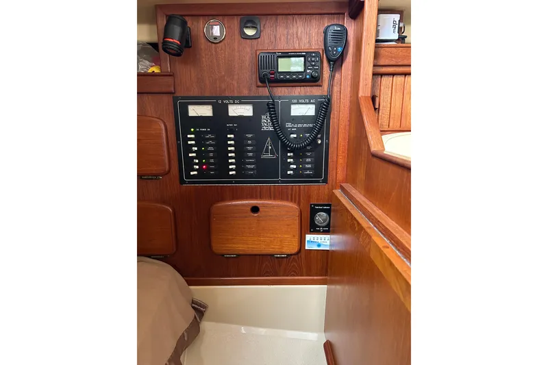 Slide: The Image of 1997 Island Packet 29 sailboat electrical panel with radio and controls. - 10