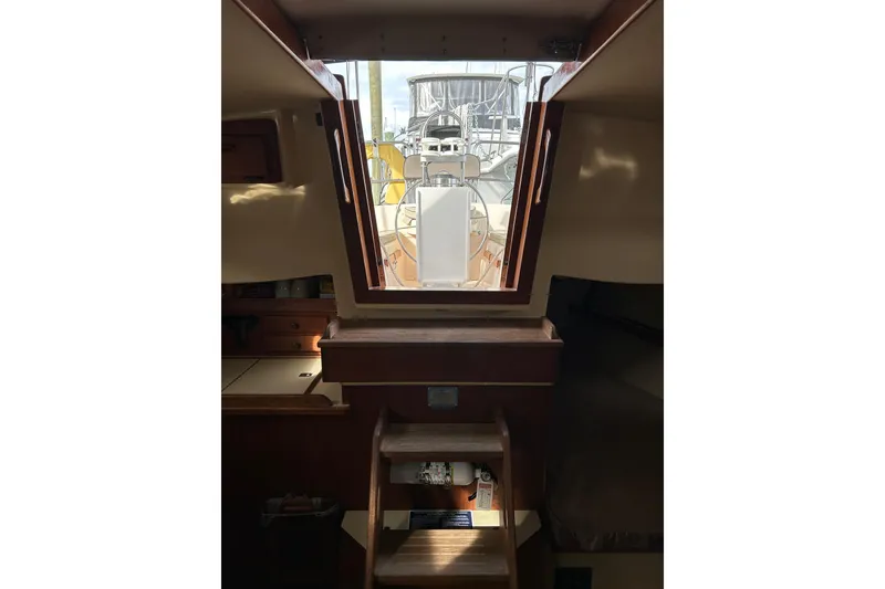 Slide: The Image of Interior view of a 1997 Island Packet 29 sailboat, showing cabin stairs and open hatch. - 12