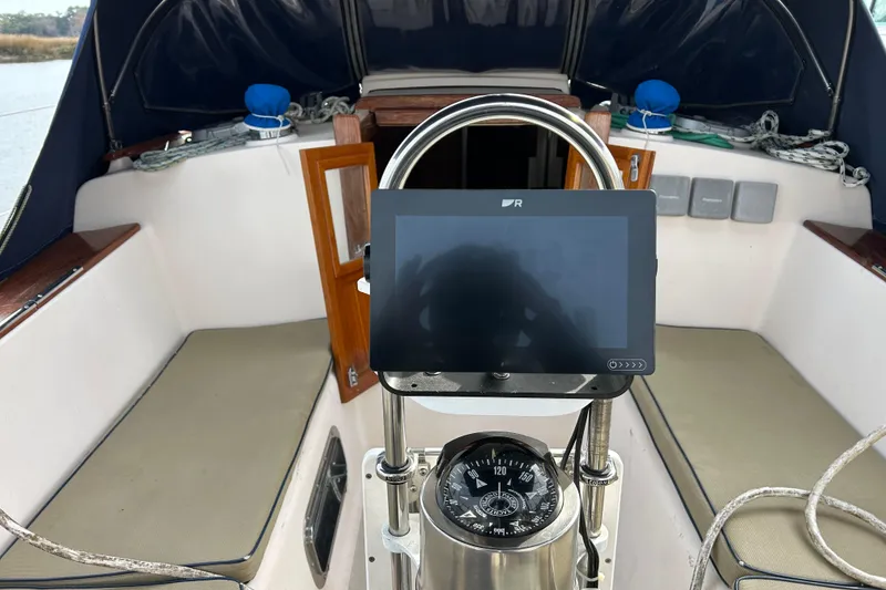 Slide: The Image of Cockpit of 1997 Island Packet 29 sailboat with navigation equipment and compass. - 14