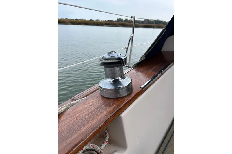 Slide: The Image of Winch on 1997 Island Packet 29 sailboat deck by the water. - 17