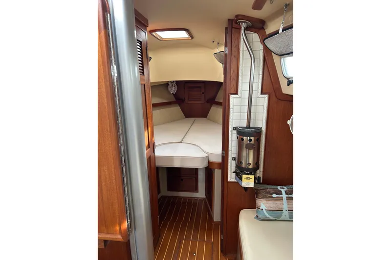 Slide: The Image of Interior of 1997 Island Packet 29 sailboat with cozy cabin and wooden finishes. - 4