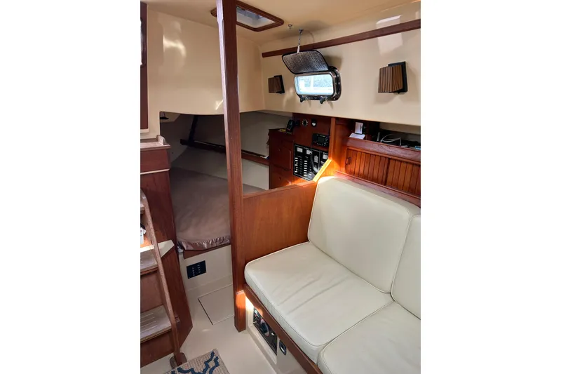 Slide: The Image of Interior of 1997 Island Packet 29 sailboat with seating and navigation area. - 9