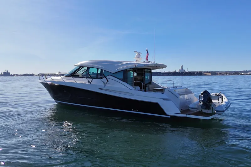 Slide: The Image of 2016 Tiara Yachts 50 Coupe on calm water, showcasing sleek design and luxury features. - 10