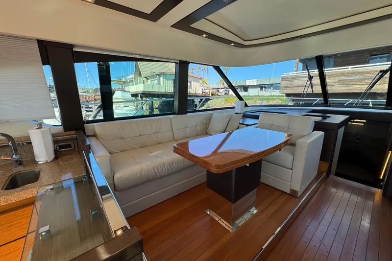 Slide: The Image of Luxurious interior of 2016 Tiara Yachts 50 Coupe with leather seating and wooden table. - 18