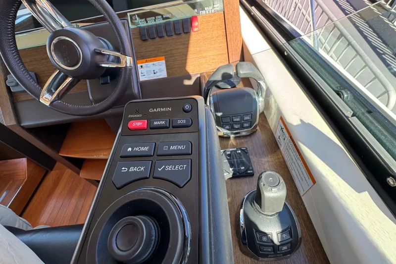 Slide: The Image of 2016 Tiara Yachts 50 Coupe helm with Garmin controls and steering wheel. - 20