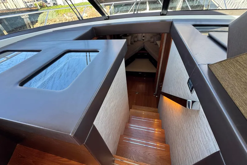 Slide: The Image of Interior view of 2016 Tiara Yachts 50 Coupe, featuring elegant wooden stairs and modern design. - 21