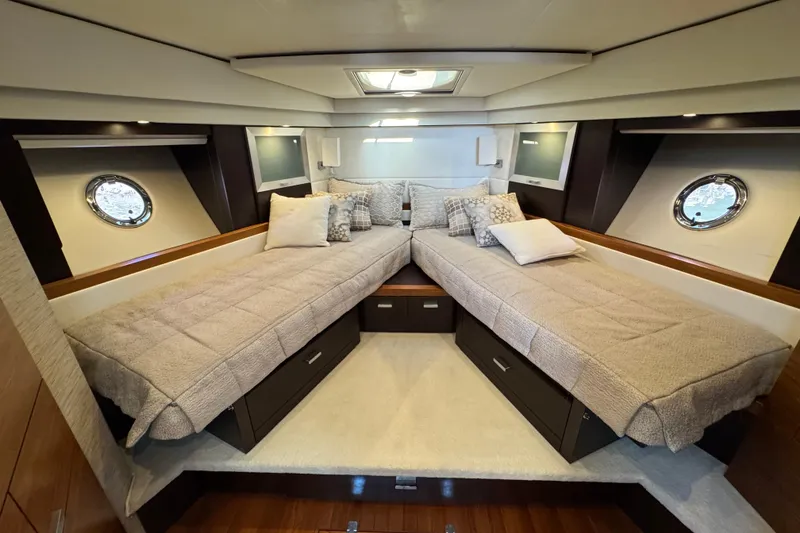 Slide: The Image of Luxurious 2016 Tiara Yachts 50 Coupe cabin with twin beds and elegant decor. - 22