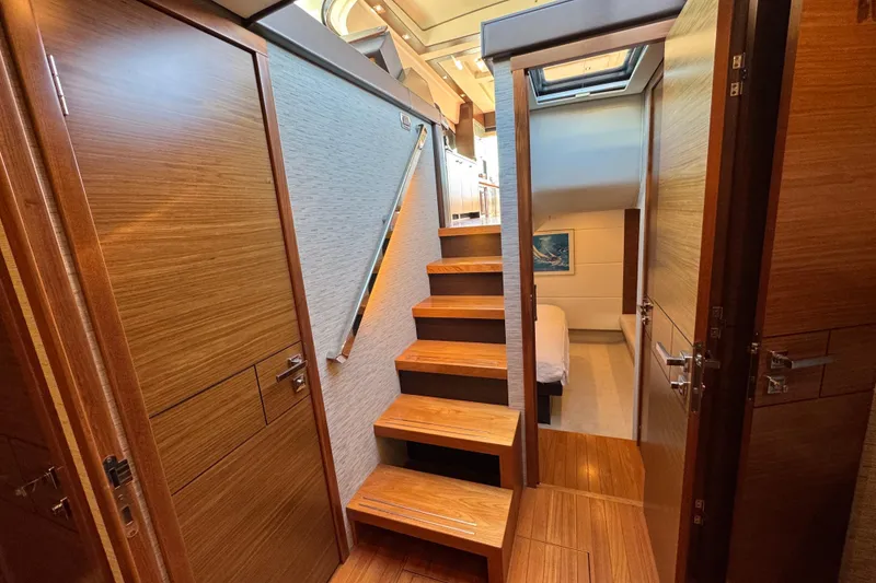 Slide: The Image of Interior of 2016 Tiara Yachts 50 Coupe, featuring wooden stairs and modern design. - 25