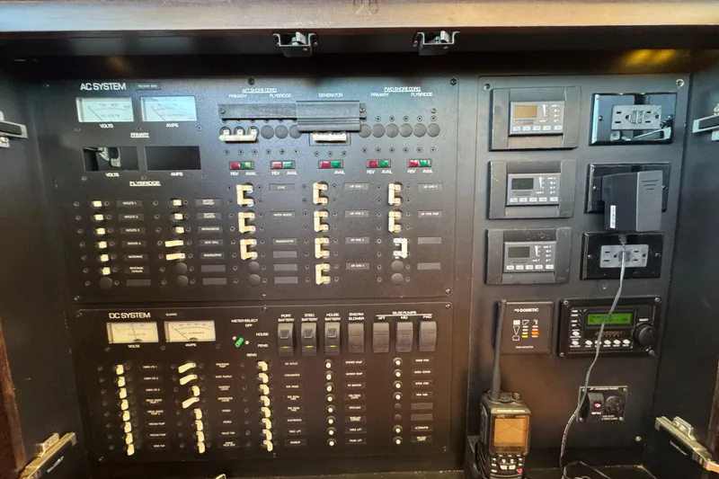 Slide: The Image of Electrical control panel of a 2016 Tiara Yachts 50 Coupe, featuring AC and DC systems. - 29