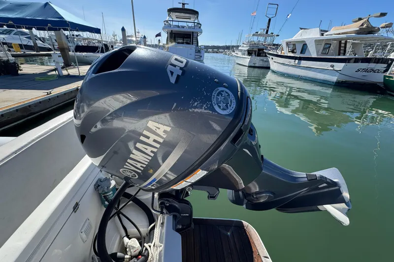 Slide: The Image of Outboard motor on a 2016 Tiara Yachts 50 Coupe, docked at a marina. - 38