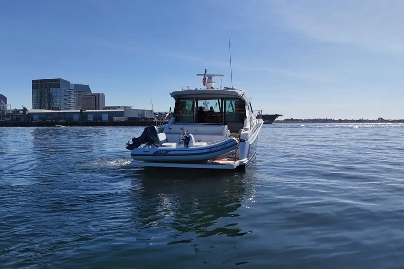 Slide: The Image of 2016 Tiara Yachts 50 Coupe on calm water near urban skyline. - 8