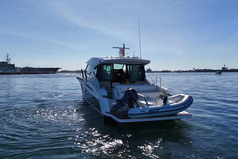 Slide: The Image of 2016 Tiara Yachts 50 Coupe on calm water with clear blue sky. - 9