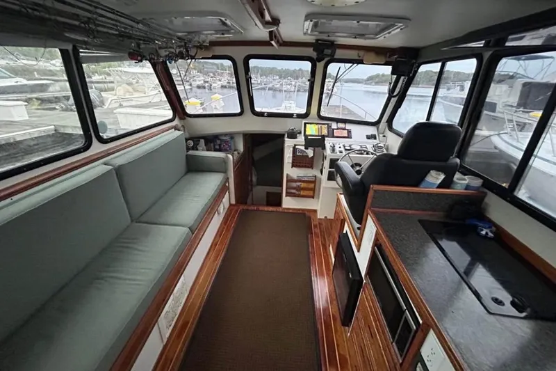 Slide: The Image of Interior of a 1998 Eastern JC Casco Bay 31' boat with seating and navigation area. - 3
