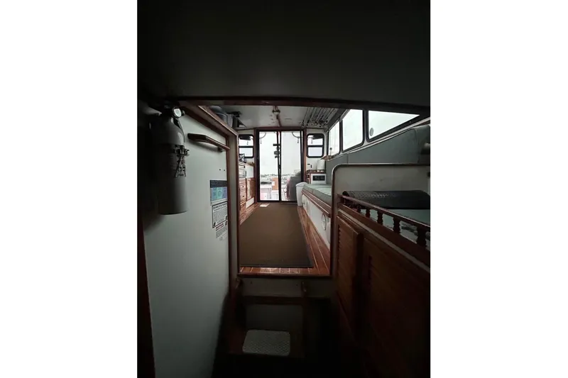 Slide: The Image of Interior view of 1998 Eastern JC Casco Bay 31' boat, featuring wooden accents and a fire extinguisher. - 4