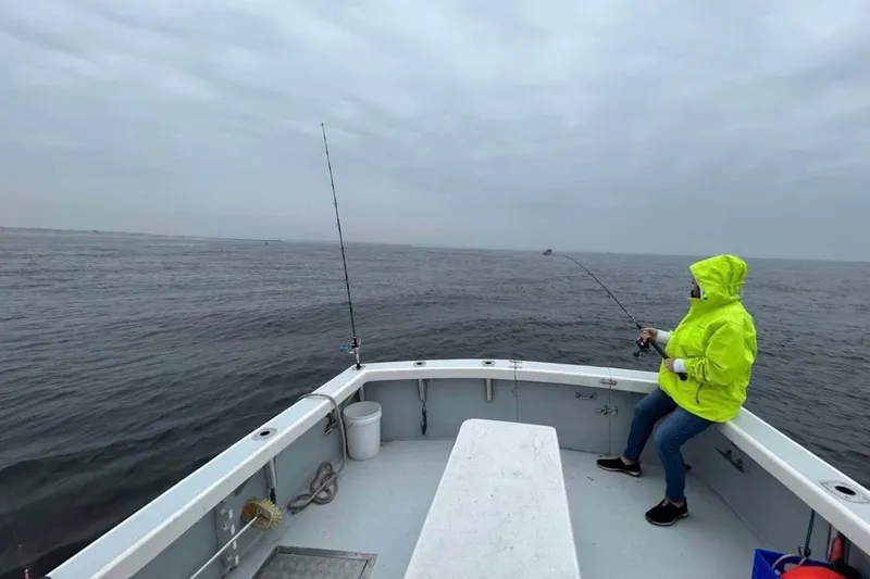 Slide: The Image of Person fishing on a 1998 Eastern JC Casco Bay 31' boat in overcast weather. - 5