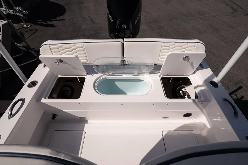 Slide: The Image of 2026 Twin Vee 22 Baycat boat interior with storage compartments and seating. - 13