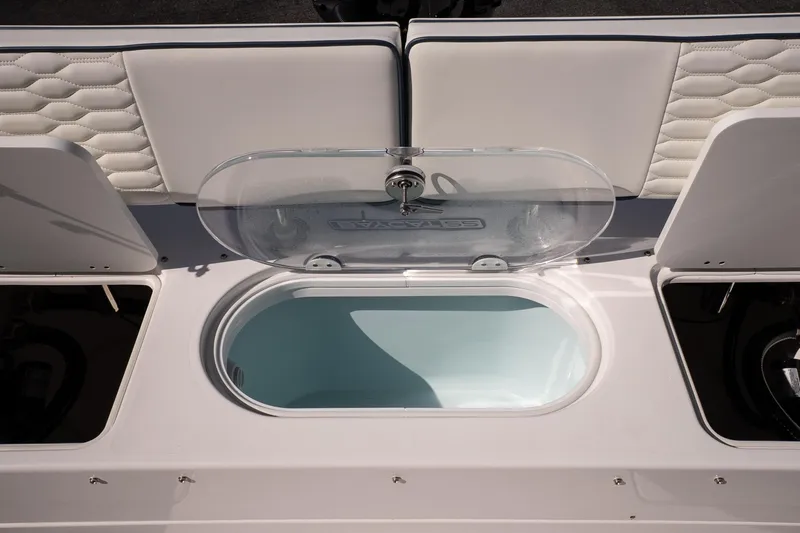 Slide: The Image of 2026 Twin Vee 22 Baycat boat interior with open storage compartment. - 14