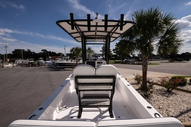 Slide: The Image of 2026 Twin Vee 22 Baycat boat parked outdoors, showcasing seating and T-top design. - 15