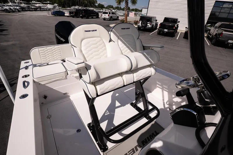 Slide: The Image of 2026 Twin Vee 22 Baycat boat interior with white cushioned seating and steering console. - 17