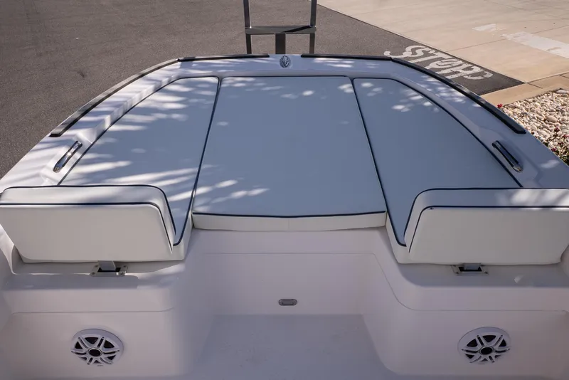 Slide: The Image of 2026 Twin Vee 22 Baycat boat deck with cushioned seating and speakers. - 24