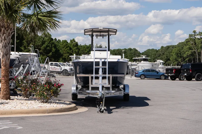 Slide: The Image of 2026 Twin Vee 22 Baycat boat on trailer in sunny parking lot. - 4