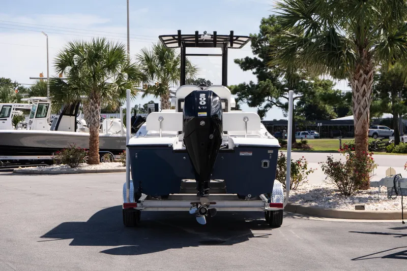 Slide: The Image of 2026 Twin Vee 22 Baycat boat on trailer, surrounded by palm trees in a parking lot. - 8