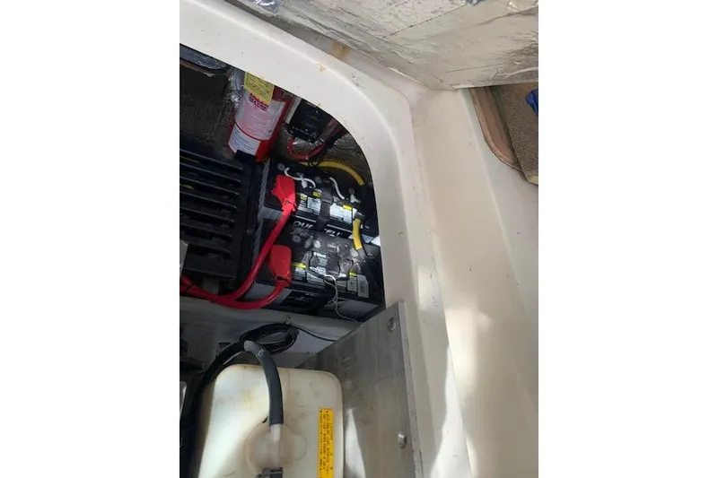 Slide: The Image of 2004 Mainship Pilot 30-II engine compartment with batteries and fire extinguisher. - 21