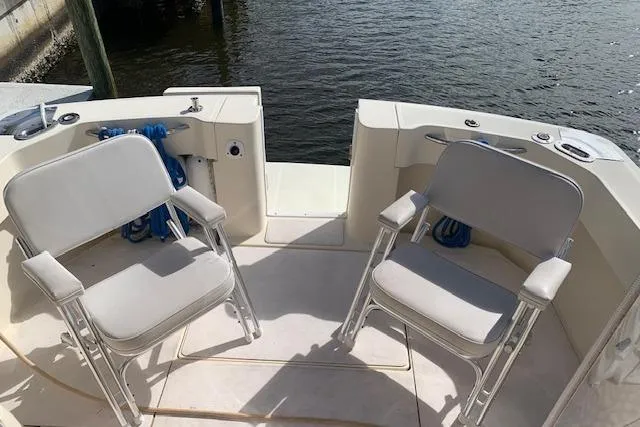 Slide: The Image of 2004 Mainship Pilot 30-II boat deck with two chairs, overlooking water. - 6