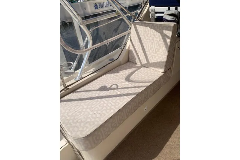 Slide: The Image of 2004 Mainship Pilot 30-II boat interior with cushioned seating and railing. - 7